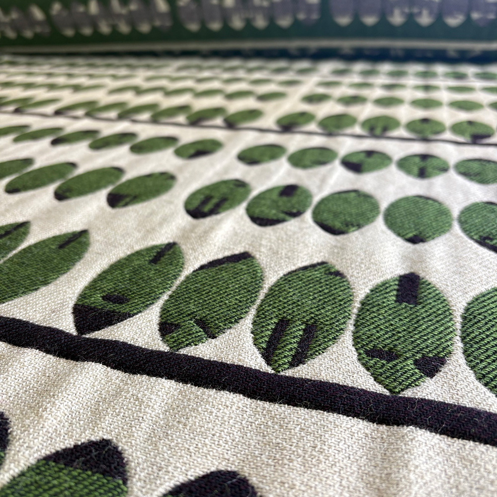 Casgliad Clustnodau - Green, aubergine and ecru coloured blanket